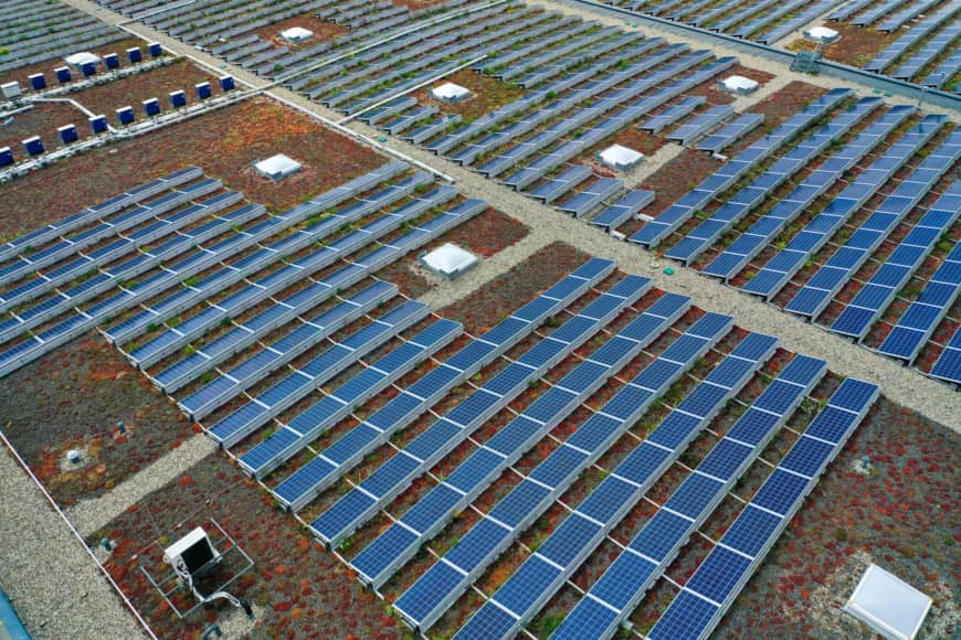 Solar panels sit on top of a warehouse near the hydrogen electrolysis plant at Energiepark Mainz